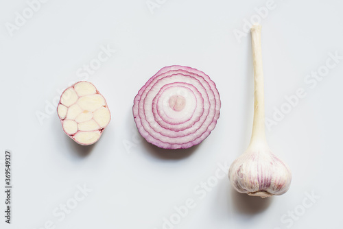 top view of cut red onion and garlic on white background