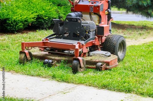 Close up of man using a lawn mower a gardener cutting grass by lawn mower