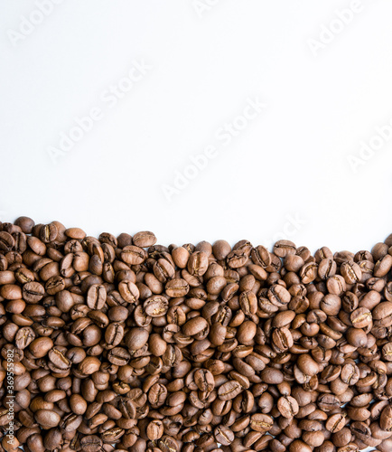 Roasted coffee beans pile isolated on white background from top view