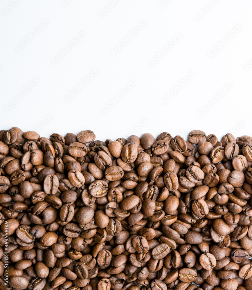 Roasted coffee beans pile isolated on white background from top view Roasted coffee beans pile isolated on white background from top view
