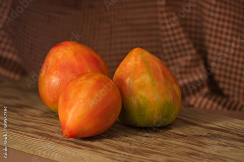 Still life of red Valencia tomatoes on dark background