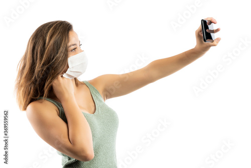 Young woman wearing medical face mask, studio portrait