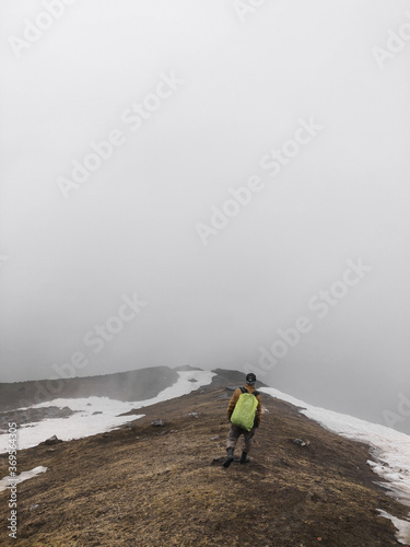 Beautiful shot of a young Asian male trekking in Chalal Trek Trail Sosan India