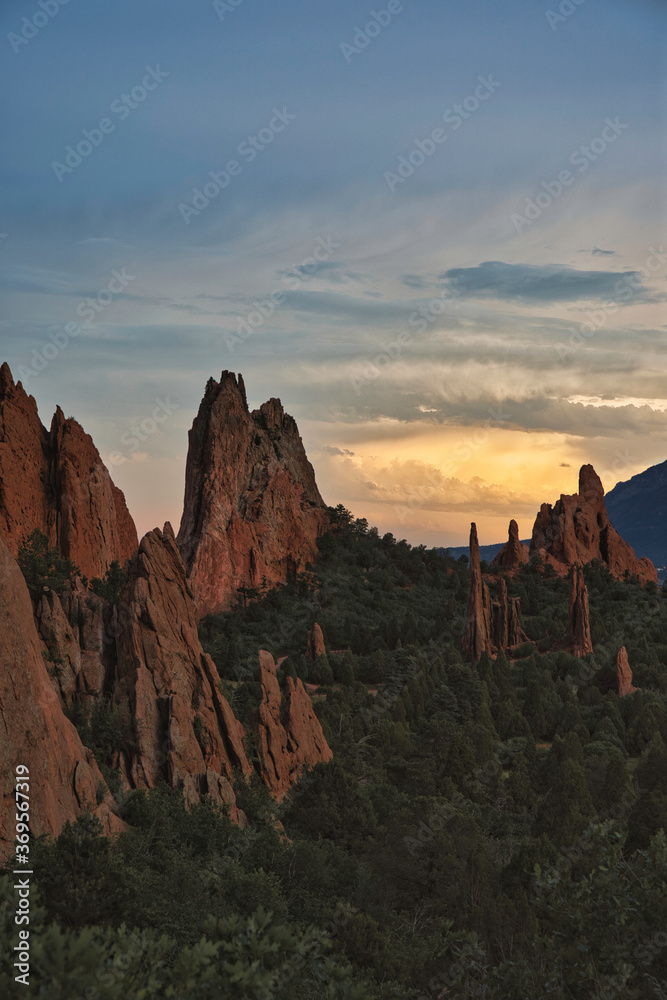 Long exposure sunset at Garden of the Gods in Colorado Springs. Sun casts golden eye in the distance