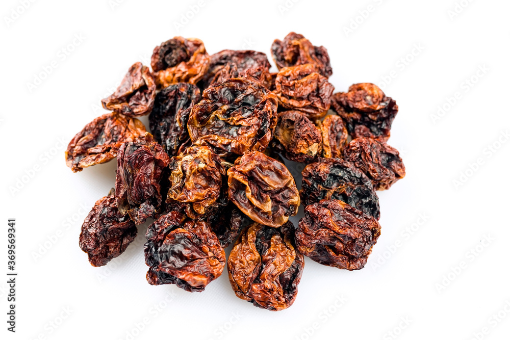 Dried Mexican hot Chile habanero seco chili offered as close-up on white background with copy space - free-form select Dried Mexican hot Chile habanero seco chili offered as close-up on white background with copy space - free-form select