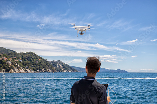 Drone flies over the sea under the control of the professional operator