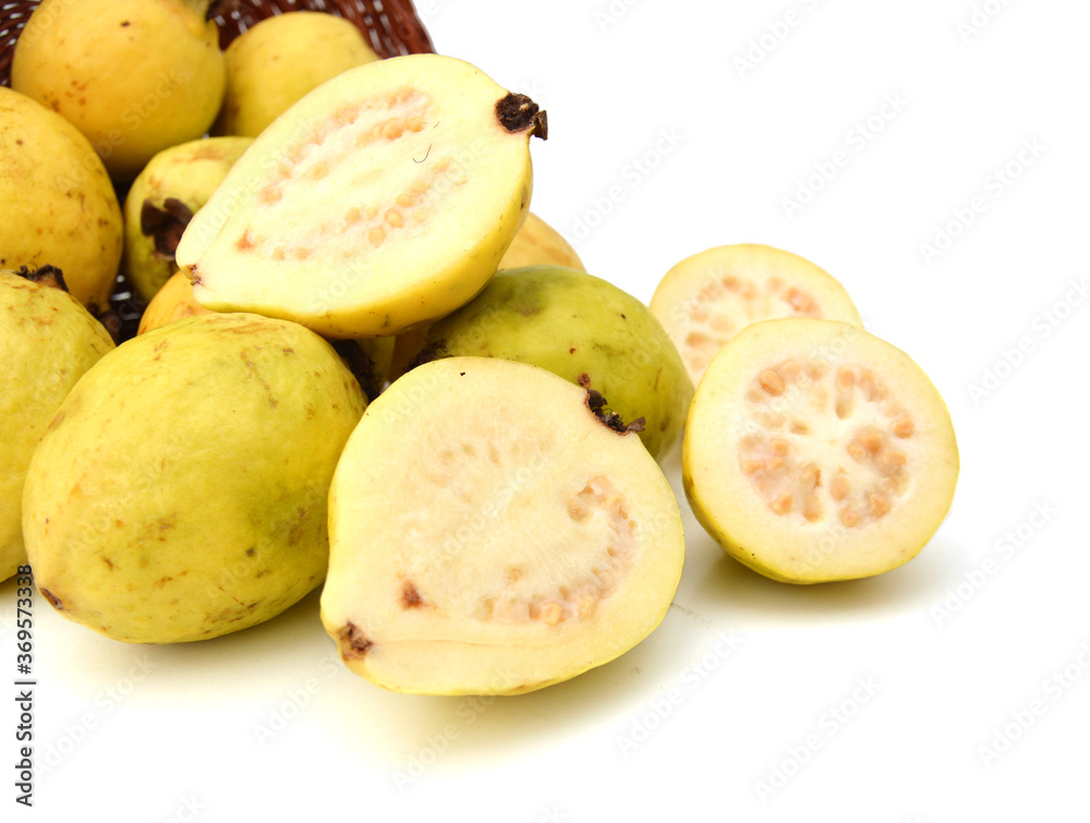 Guava Fruits And Slices Isolated in basket on White Background Guava Fruits And Slices Isolated in basket on White Background