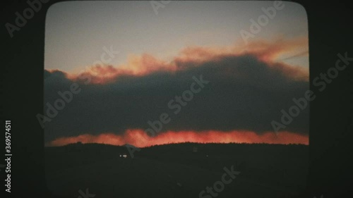 Road Trip with wildfires in the horizon. Point of view driving, first person. Vintage Film Look. 