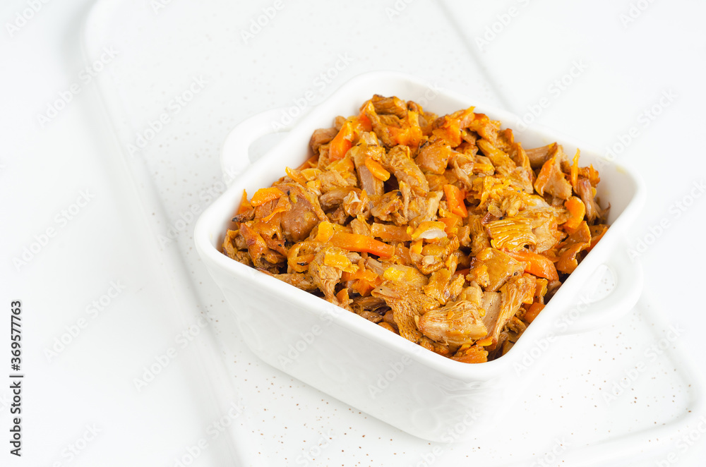 Fried mushrooms with carrots on a white background Fried mushrooms with carrots on a white background