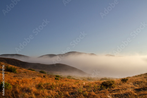 California Landscape of mountains and fog at sunrise, Point Mugu State Park near Malibu, California.