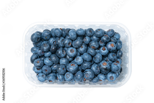 Top view of plastic bowl full of blueberries isolated on white background. Ripe blueberry retail package.