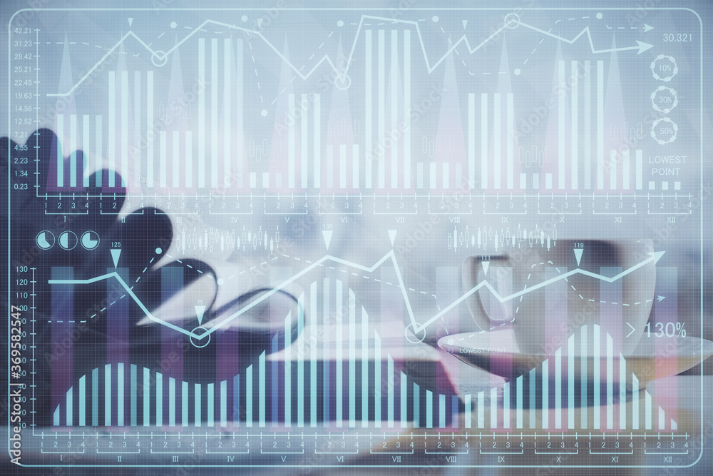 Double exposure of financial chart drawing and desktop with coffee and items on table background. Concept of forex market trading Double exposure of financial chart drawing and desktop with coffee and items on table background. Concept of forex market trading