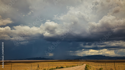 Dramatic monsoon storm cloud dumps rain over a field in Arizona. 