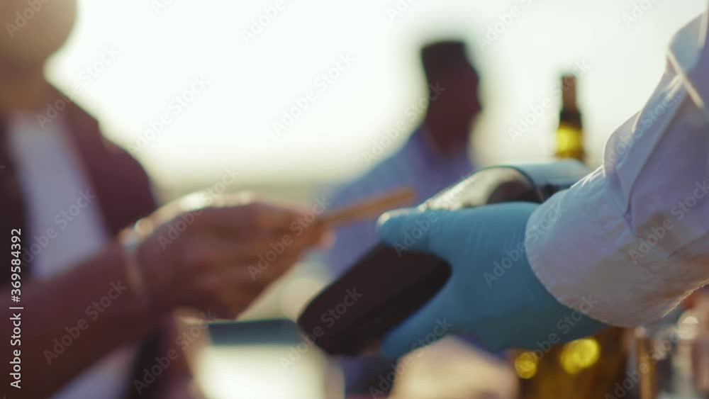 Close up hands man payment with credit card finance money paying terminal transaction communication machine electronic shopping checkout gloves outdoors digital slow motion Close up hands man payment with credit card finance money paying terminal transaction communication machine electronic shopping checkout gloves outdoors digital slow motion