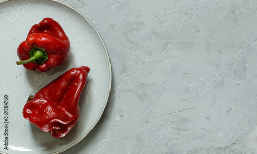 a couple of ugly red peppers on a plate. Horizontal orientation with space, top photo