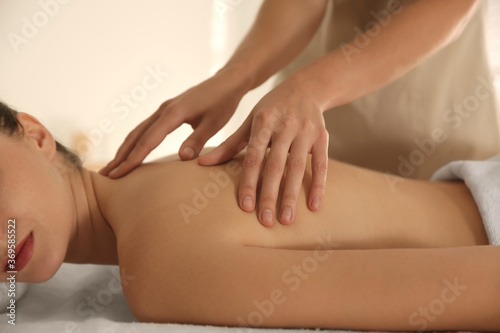 Young woman receiving back massage in spa salon  closeup
