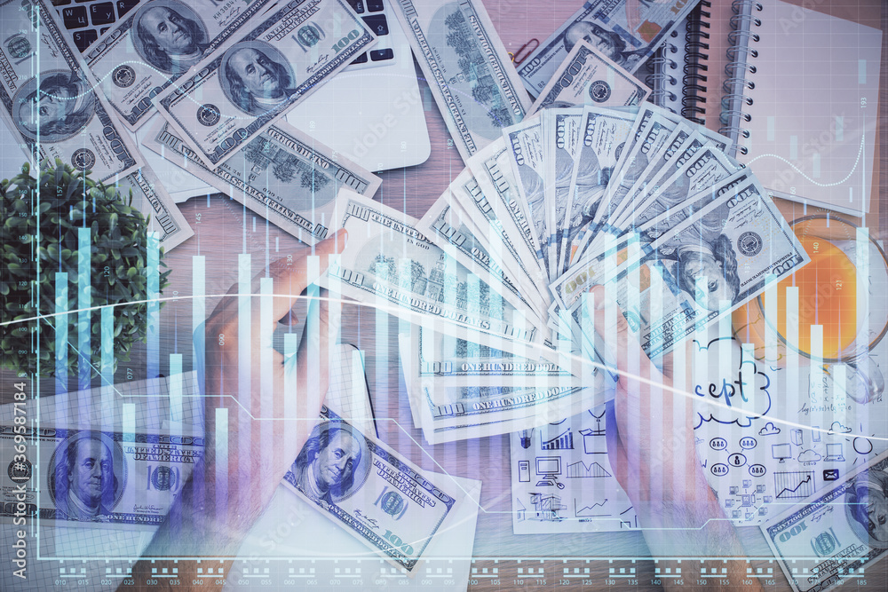 Fototapeta premium Multi exposure of financial graph drawing hologram and USA dollars bills and man hands. Analysis concept.