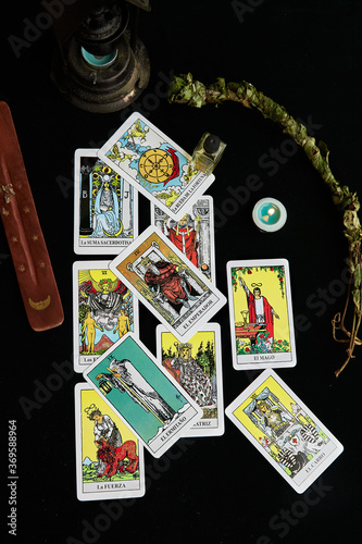 Tarot cards, candle, incense, sage, cauldron and essence.
