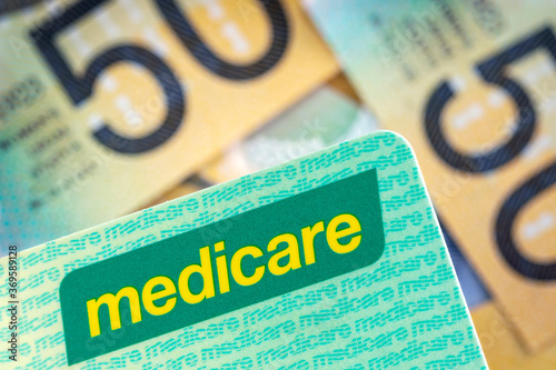 Australian Medicare Card over Blurred Money Background photo