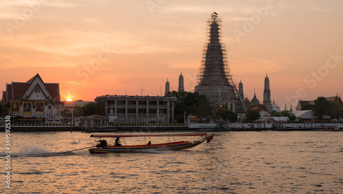 Photography boat on river in front of temple in bangkok