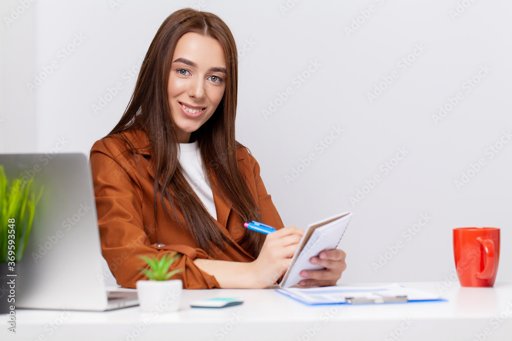 Happy beautiful business woman with clipboard in the office. Happy beautiful business woman with clipboard in the office.