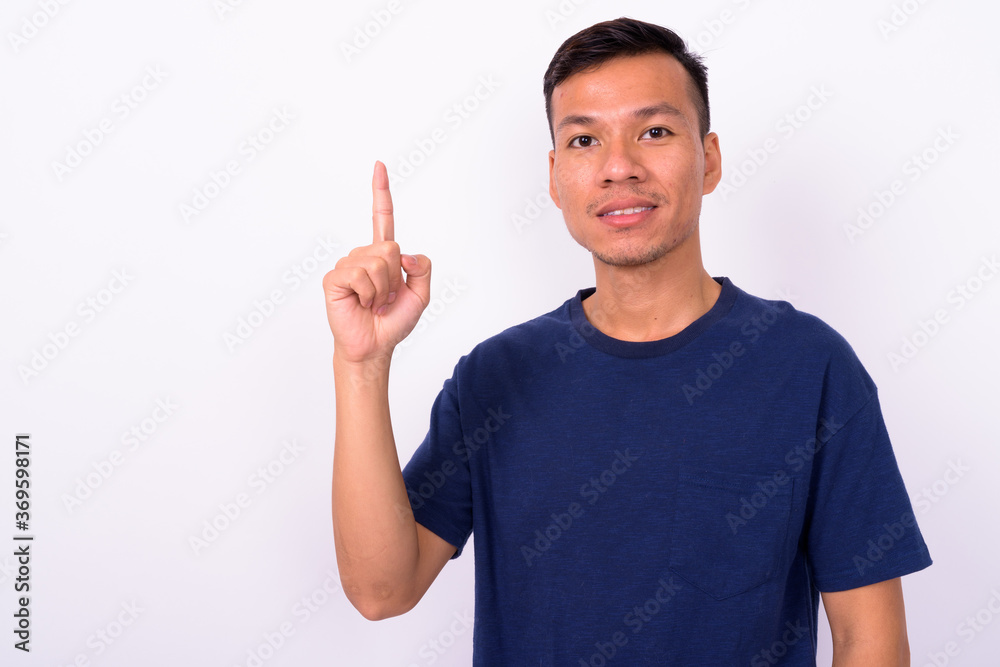 Portrait of happy young Asian man with beard stubble Portrait of happy young Asian man with beard stubble