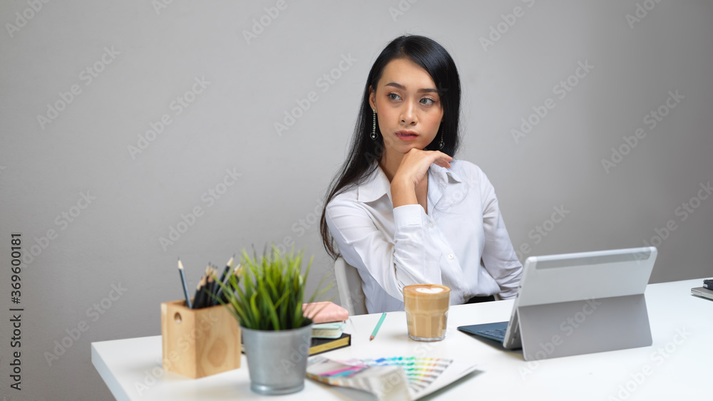 Portrait of female designer sitting at her office desk Portrait of female designer sitting at her office desk