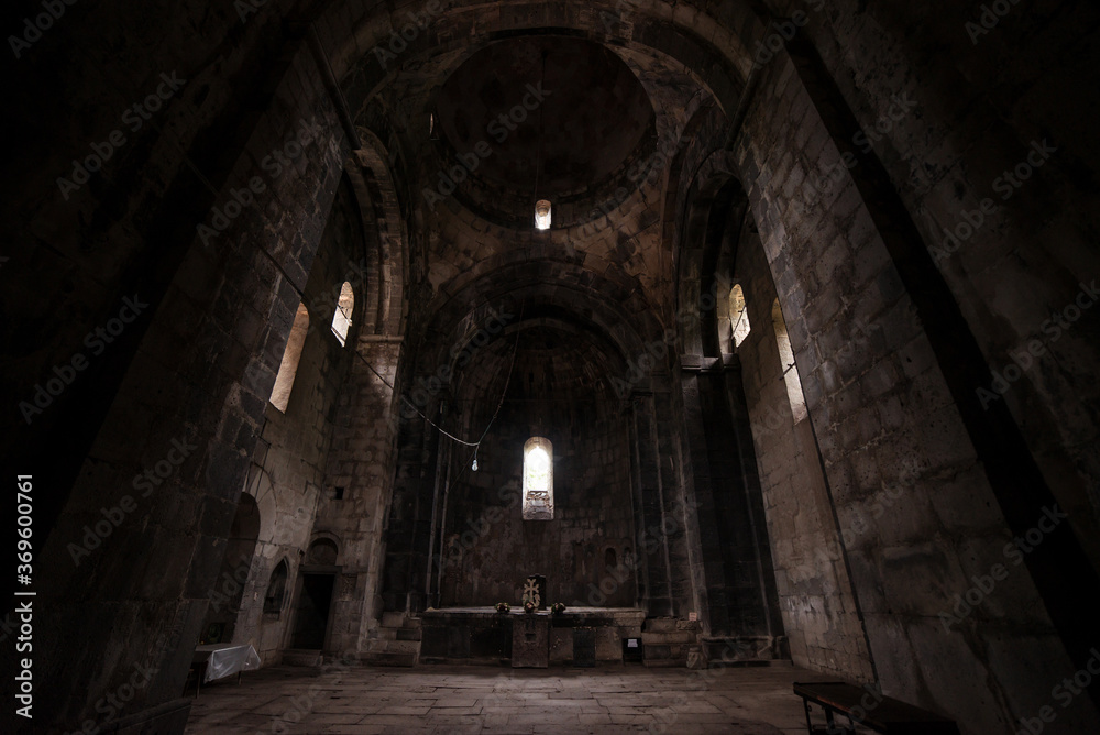 Obraz premium Interior of Sanahin Monastery with ray of light entering through narrow window and altar