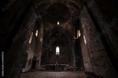 Interior of Sanahin Monastery with ray of light entering through narrow window and altar