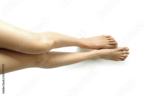 Beautiful perfect woman legs and feet on isolated white background. Concept beauty and hydration of the skin. photo