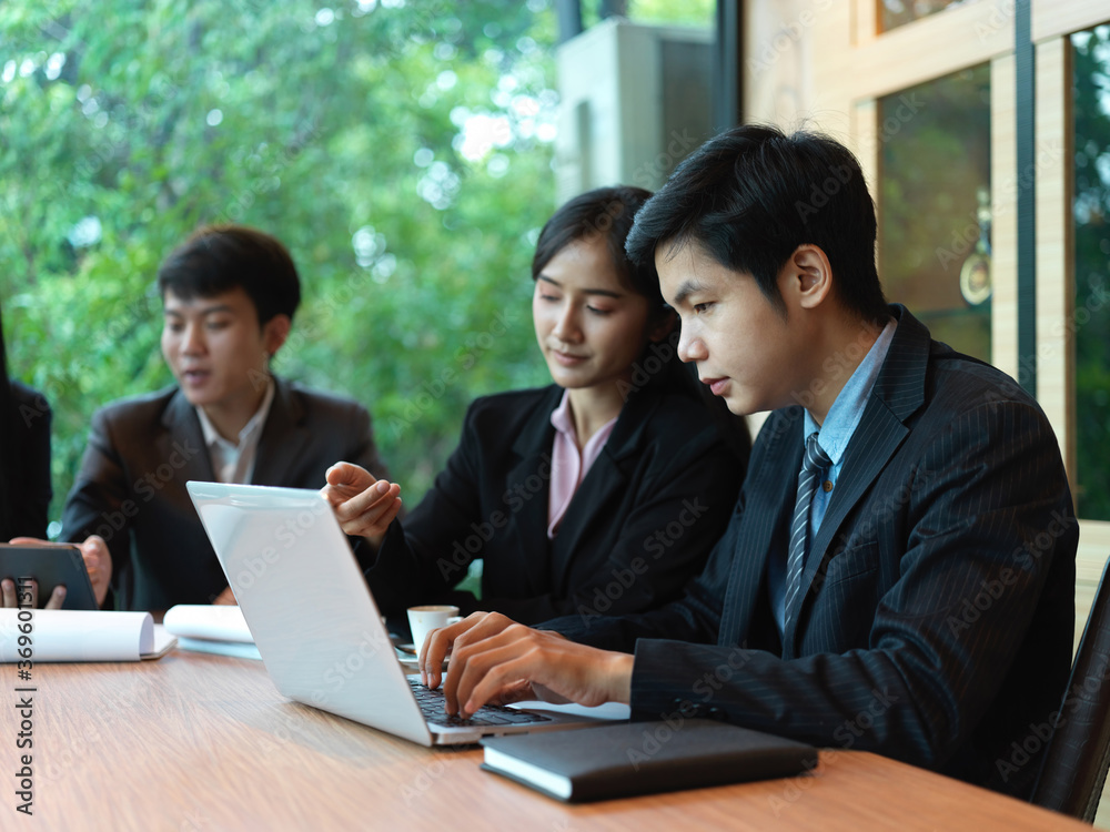 Portrait of office workers brainstorming on their project in meeting room Portrait of office workers brainstorming on their project in meeting room