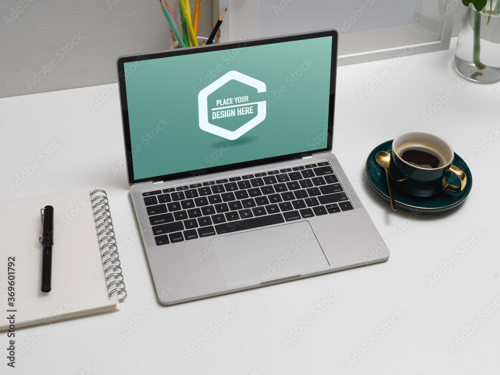 Modern home office desk with mock up laptop, stationery, coffee cup and decorations Modern home office desk with mock up laptop, stationery, coffee cup and decorations