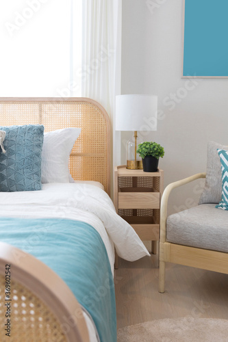 Cozy blue bedroom with modern interior  ethnic decor  comfortable bed  lamp over bedside table.