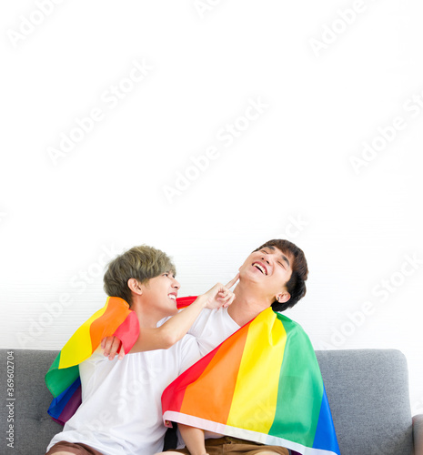Happy Asian homosexual couples with a rainbow flag.