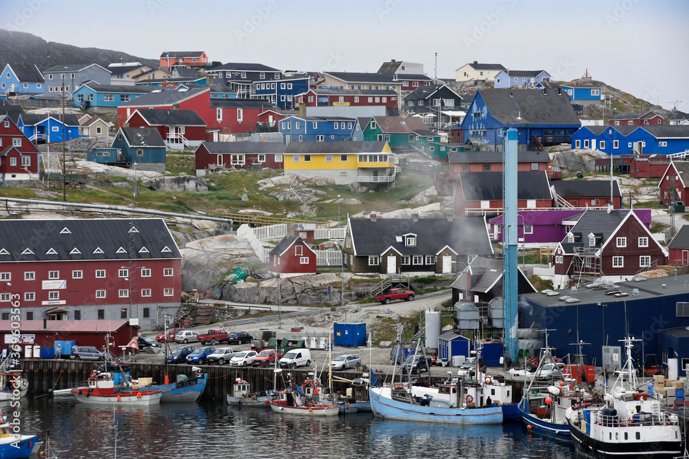 Colorful buildings overlook the fishing harbor in Ilulissat, West Greenland