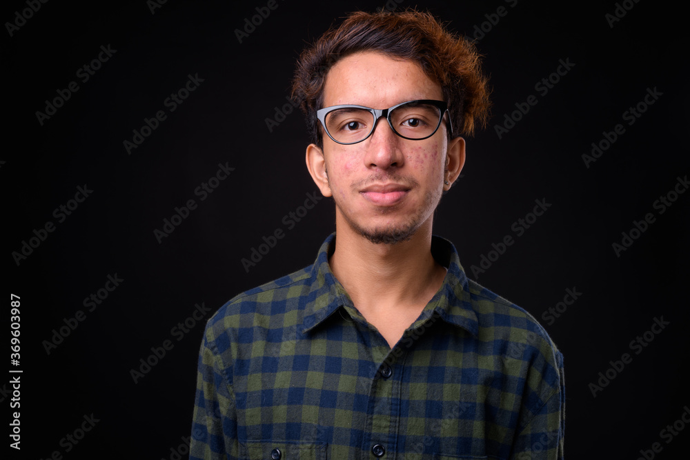 Portrait of young Asian hipster man with curly hair Portrait of young Asian hipster man with curly hair