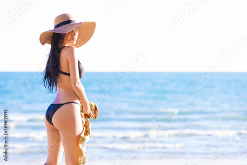 Beautiful sexy asian women in a sexy bikini on tropical beach 