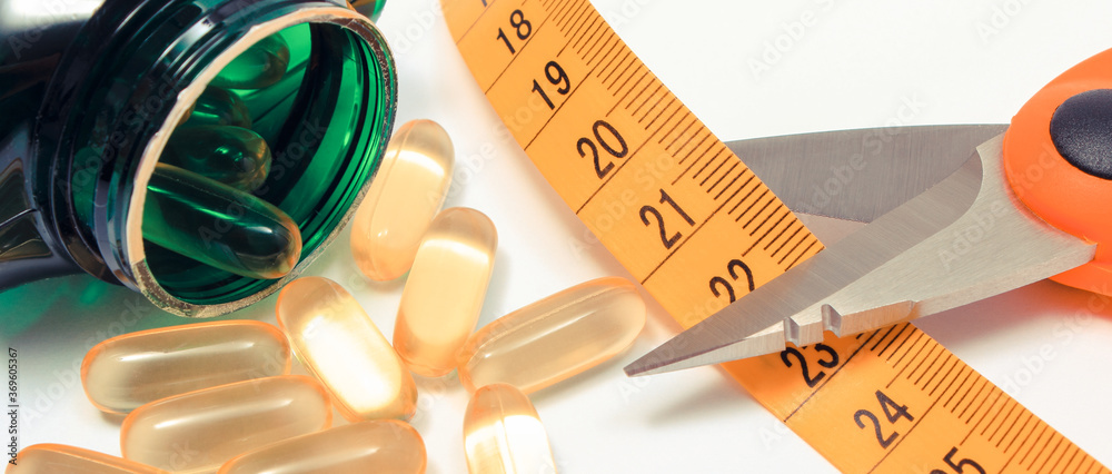 Εκτύπωση καμβά Tablets or supplements and scissors cutting tape measure on white background, sl