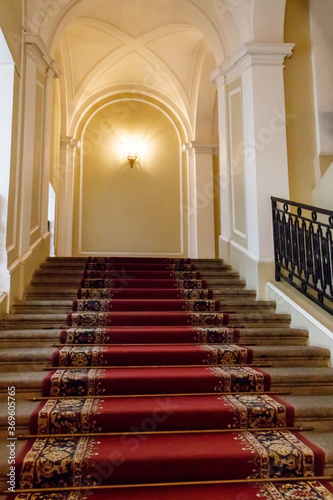 Red carpet on the staircase in luxury interior