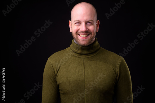 Portrait of happy handsome bald bearded man