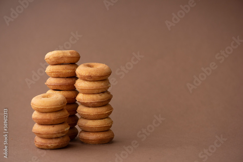 fresh small round donuts on brown background
