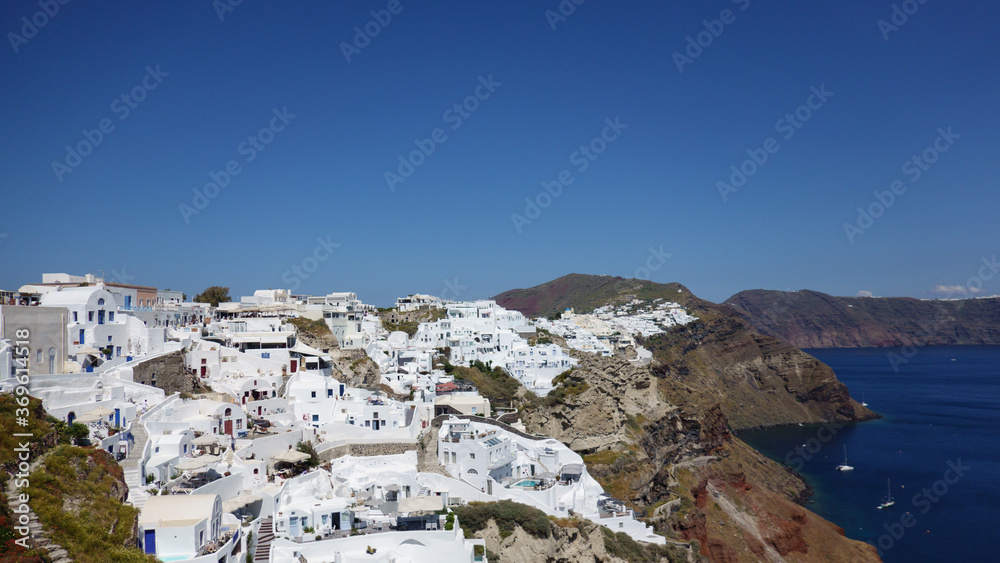View of the island and whitewashed village of Oia of Santorini, Greece.