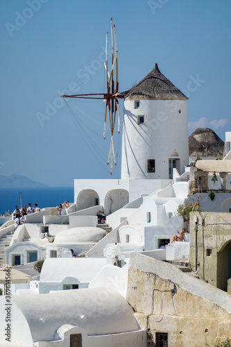 Architecture with windmills on a hillside in Oia village on Santorini island, Greece Mediterranean sea.