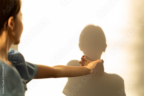 Bild auf Leinwand Woman is crazy, suffocating her shadow with hands squeezing neck.