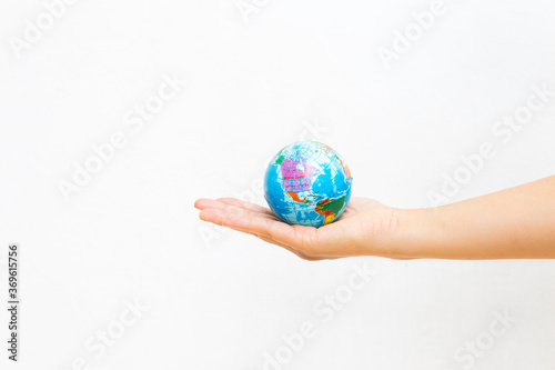 World map foam Earth Globe stress relief bouncy ball in girl hand on white background  world environmental