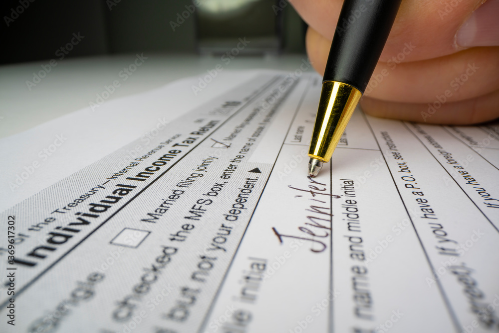 Close-up view of completing US tax form Close-up view of completing US tax form