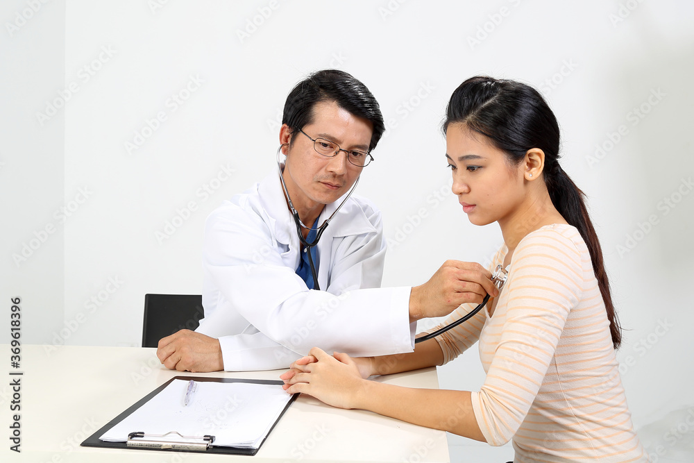Young Asian male doctor wearing apron uniform stethoscope female patient talk discuss cheek Young Asian male doctor wearing apron uniform stethoscope female patient talk discuss cheek