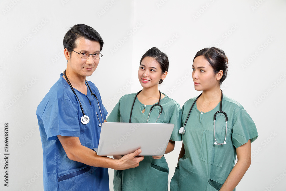 Young Asian male female doctor wearing apron uniform tunic stethoscope holding laptop talk discuss Young Asian male female doctor wearing apron uniform tunic stethoscope holding laptop talk discuss