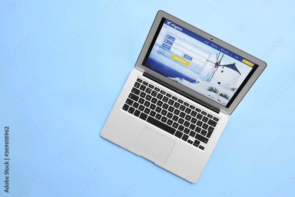 Modern laptop on color background. Concept of online booking Modern laptop on color background. Concept of online booking