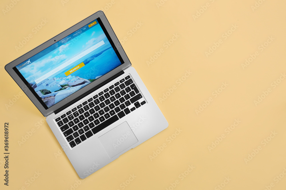 Modern laptop on color background. Concept of online booking Modern laptop on color background. Concept of online booking